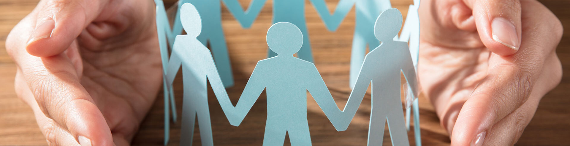 paper cutout of people holding hands