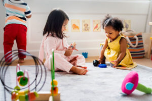 children sitting on the floor playing