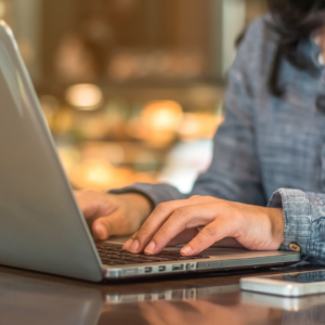 woman sitting at laptop typing