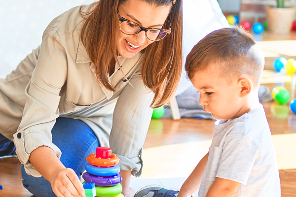 child care provider stacking tower with child