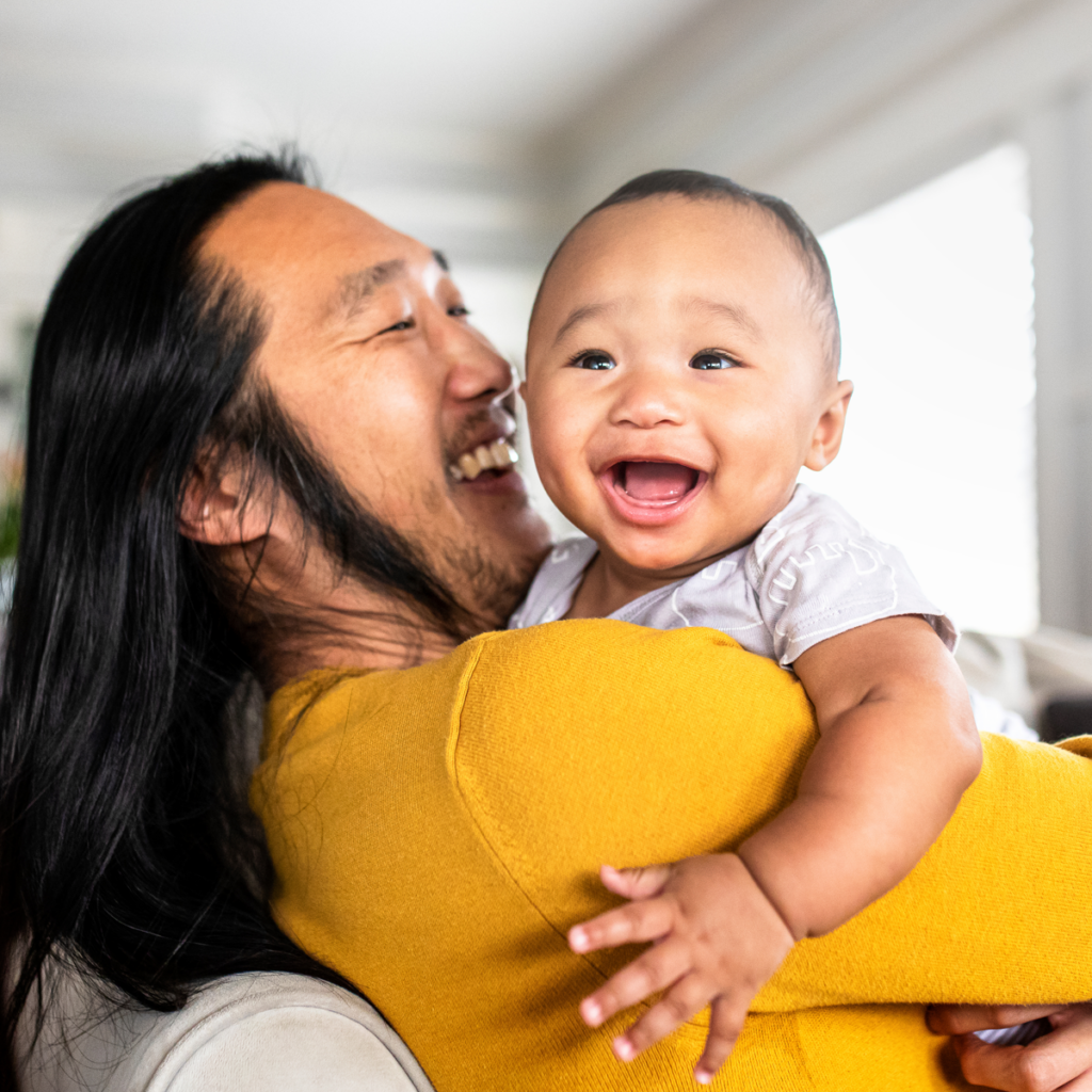 father holding son smiling