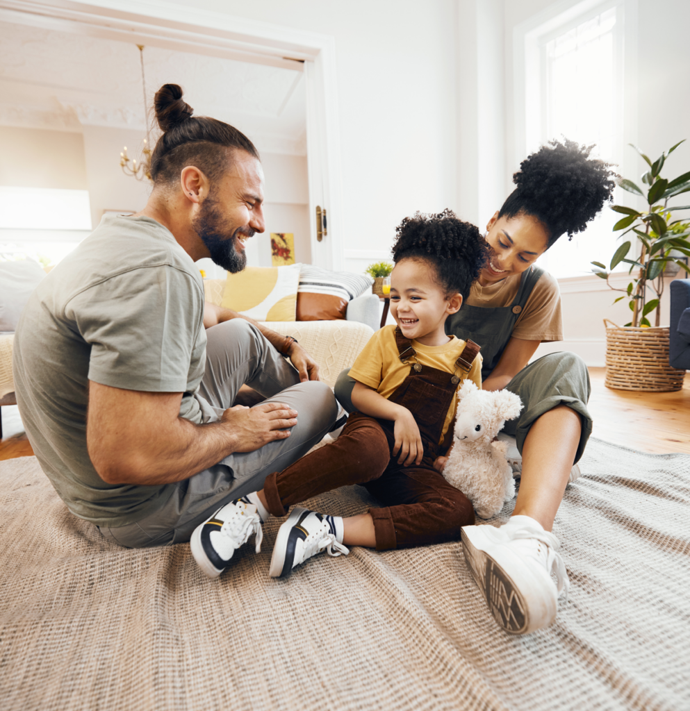 family sitting on floor and laughing