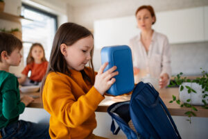 child packing backpack