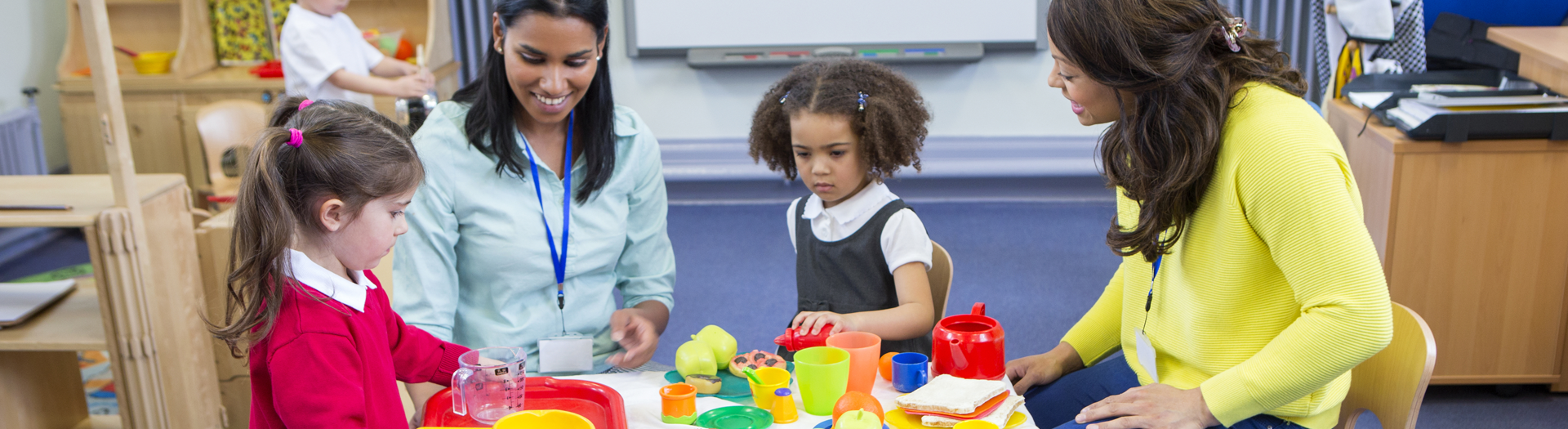 Child care providers with children in a classroom