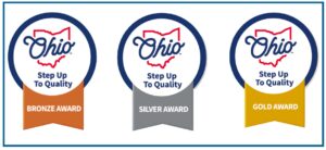 Three circular badges labeled "Ohio Step Up To Quality" with the Ohio state outline, each showing a different award level: bronze, silver, and gold.