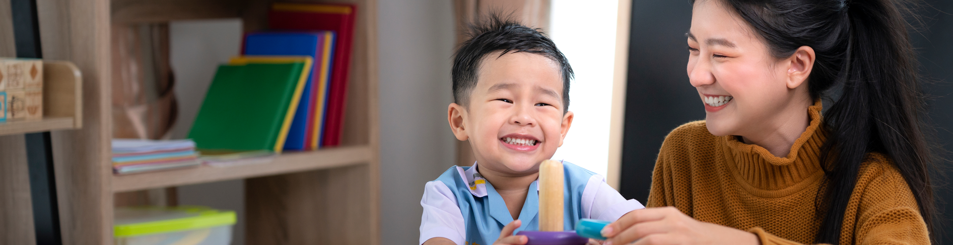 Preschool teacher with child
