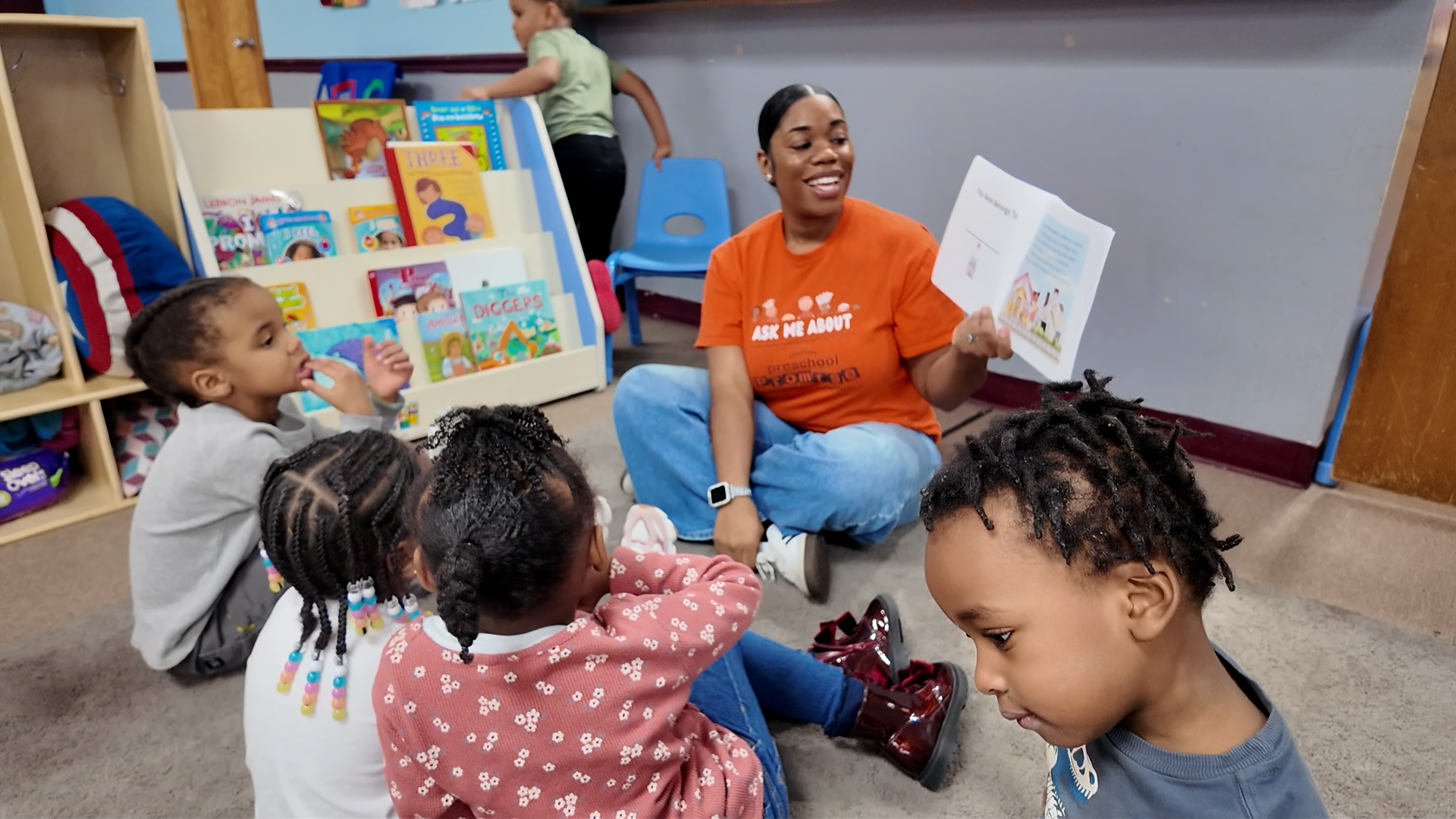 Early childhood educator reads to preschoolers